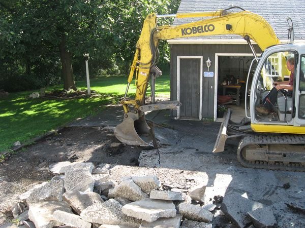 construction truck tearing apart driveway